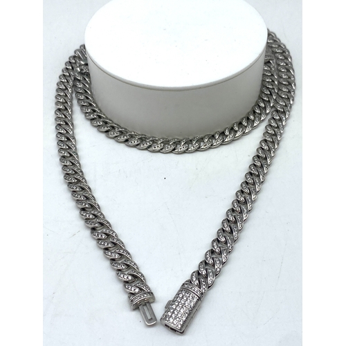 214 - A white metal curb bracelet & chain, both items are encrusted with stones, necklace 17 1/2 inches lo... 