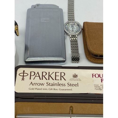 215 - A mixed lot of items, watch, parker pen, shaver set, cigarette lighter,