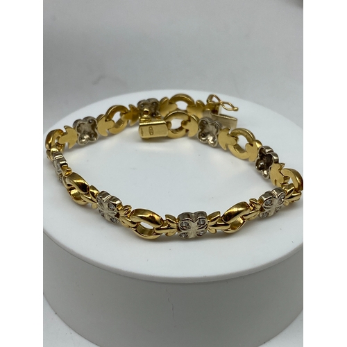 27 - An 18ct yellow & white gold diamond bracelet, 15.7 grams in weight approx, 7 1/2 inches long x 8mm w... 