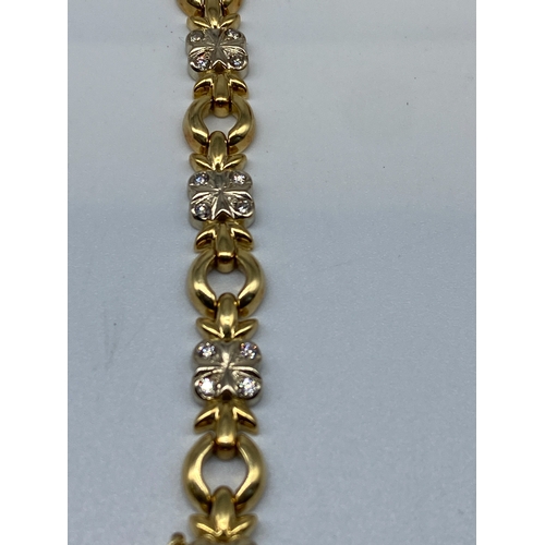 27 - An 18ct yellow & white gold diamond bracelet, 15.7 grams in weight approx, 7 1/2 inches long x 8mm w... 