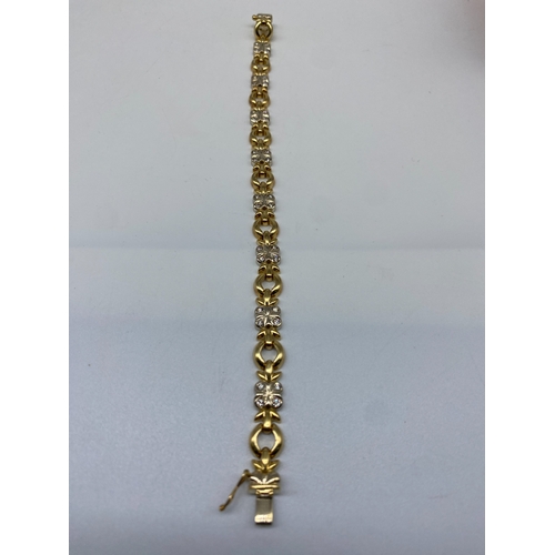 27 - An 18ct yellow & white gold diamond bracelet, 15.7 grams in weight approx, 7 1/2 inches long x 8mm w... 