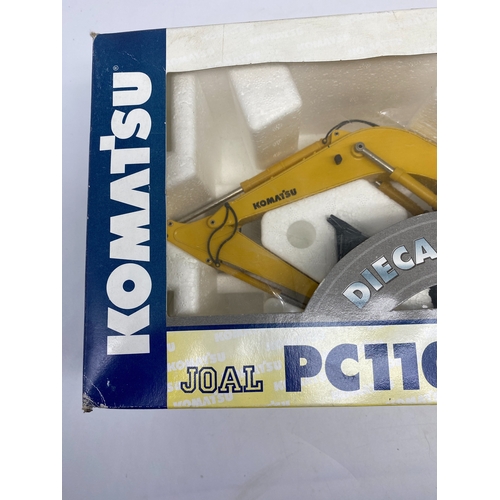 324 - A Komatsu diecast metal digger toy, toy is in mint condition never out the box, box has some storage... 