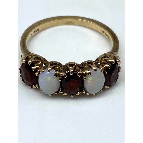 33 - A 9ct yellow gold opal & garnet dress ring, size P, 2.7 grams in weight approx