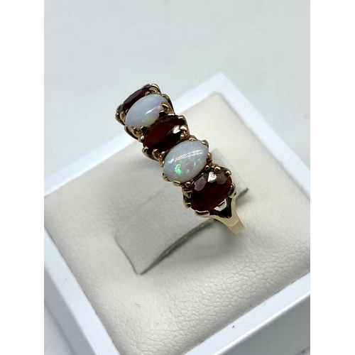 33 - A 9ct yellow gold opal & garnet dress ring, size P, 2.7 grams in weight approx