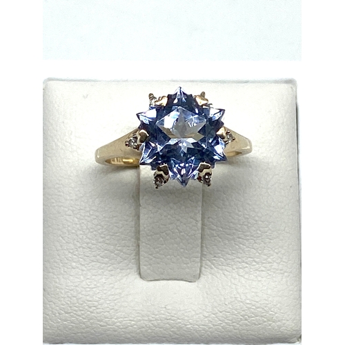 61 - A 9ct yellow gold blue stone dress ring, size L, 3.1 grams in weight approx