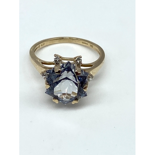 61 - A 9ct yellow gold blue stone dress ring, size L, 3.1 grams in weight approx