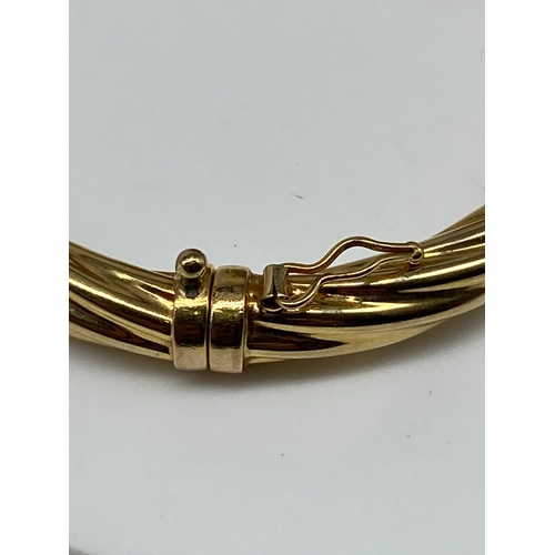 9 - A 9ct yellow gold twisted bangle, hollow bangle no metal core, 10.3 grams approx, 7 1/2 inches in si... 