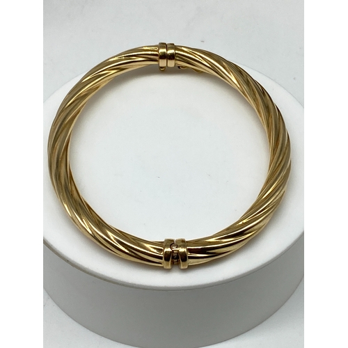 9 - A 9ct yellow gold twisted bangle, hollow bangle no metal core, 10.3 grams approx, 7 1/2 inches in si... 