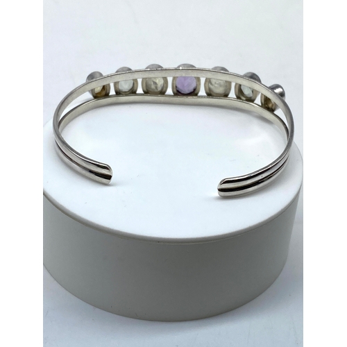 155 - A silver bangle, 23 grams, precious stones, Birmingham hall mark