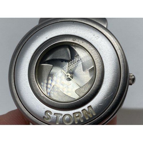 195 - A ladies Storm watch, with a camera lens mechanism, will require a battery, 35mm dial