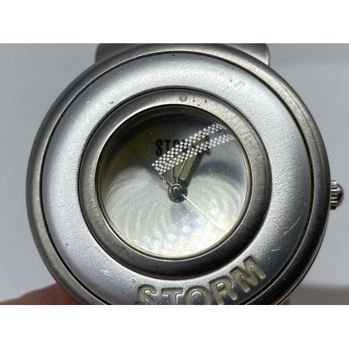 195 - A ladies Storm watch, with a camera lens mechanism, will require a battery, 35mm dial