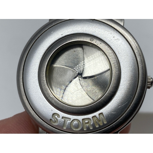 195 - A ladies Storm watch, with a camera lens mechanism, will require a battery, 35mm dial