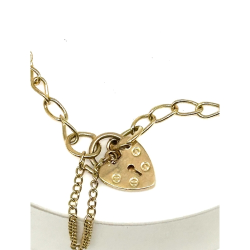 80 - A 9ct yellow gold charm bracelet, charm is a graduation cap