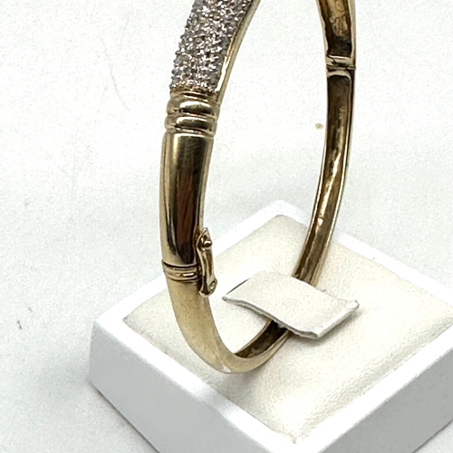 92 - A 9ct yellow gold diamond encrusted bangle, hallmarked 0.50ct diamonds in the bangle, hallmarked 375... 