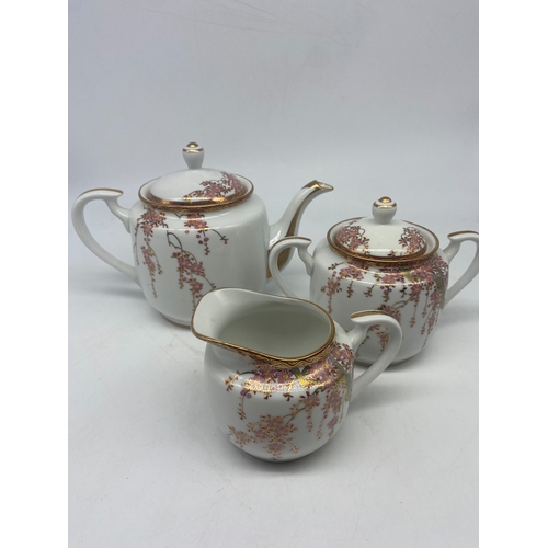 366 - A Japanese Satsuma tea set, teapot, sugar, cream jug