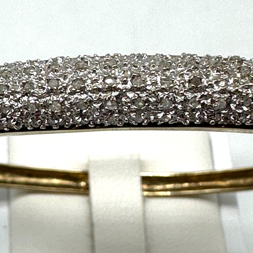 92 - A 9ct yellow gold diamond encrusted bangle, hallmarked 0.50ct diamonds in the bangle, hallmarked 375... 