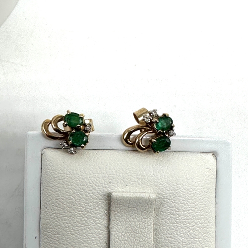 94 - A pair of 9ct yellow gold emerald & diamond stud earrings, 1.4 grams approx weight