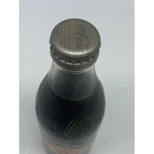 404 - A vintage coke cola bottle, original cola inside, 10floz