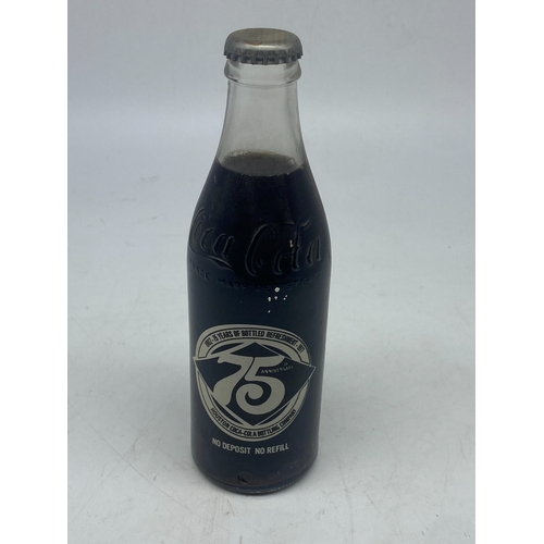 404 - A vintage coke cola bottle, original cola inside, 10floz