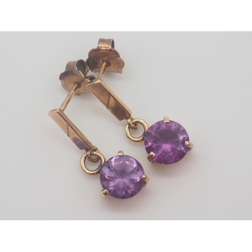 501 - A pair of 14ct yellow gold purple glass set drop earrings, round faceted glass 7.7mm each, claw set,... 