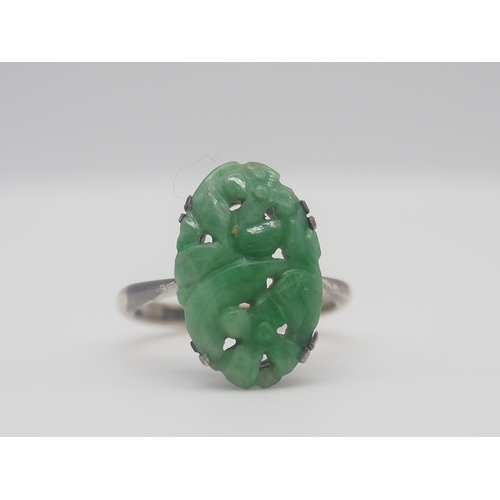 503 - A 9ct white gold carved jadeite dress ring, 3.2g approx weight,