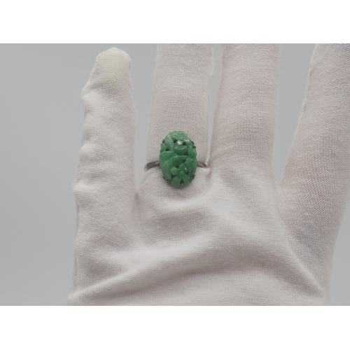 503 - A 9ct white gold carved jadeite dress ring, 3.2g approx weight,