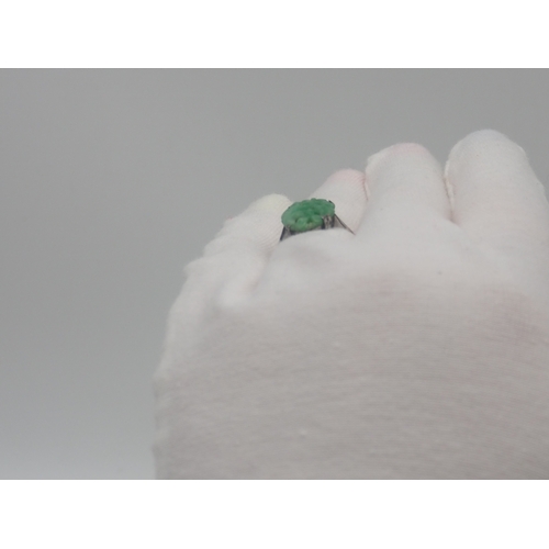 503 - A 9ct white gold carved jadeite dress ring, 3.2g approx weight,