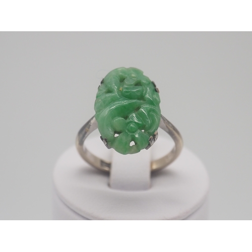 503 - A 9ct white gold carved jadeite dress ring, 3.2g approx weight,