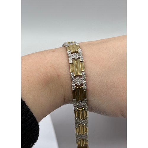 512 - A 9ct yellow gold diamond set bracelet with white gold links, 7 1/2 inches long and 8mm wide, weight... 