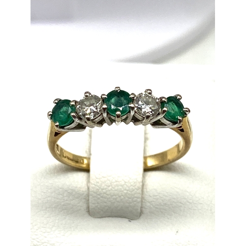 523 - An 18ct yellow gold emerald & diamond dress ring, diamonds approx 0.50ct, emeralds are 0.60ct approx... 