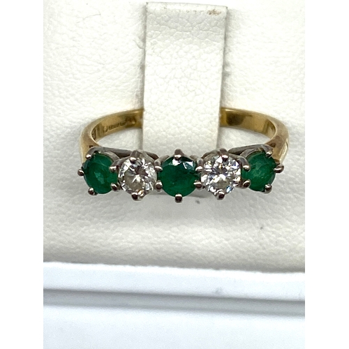 523 - An 18ct yellow gold emerald & diamond dress ring, diamonds approx 0.50ct, emeralds are 0.60ct approx... 