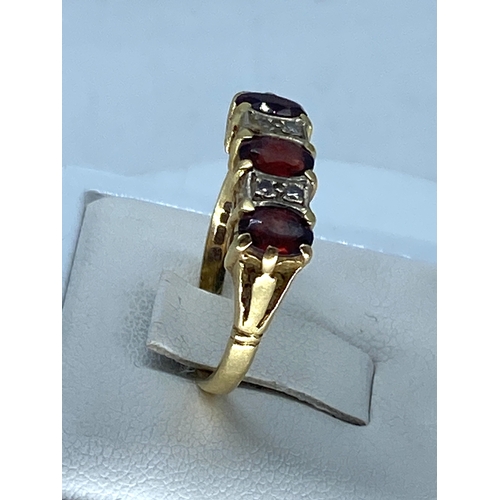 169 - An 18ct yellow gold garnet & diamond dress ring, fully hallmarked, weight is 4.6 grams approx, size ... 