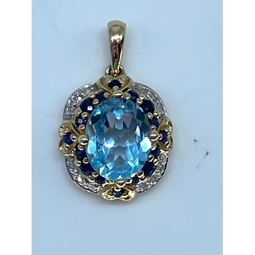 173 - A 9ct yellow gold topaz/sapphire & diamond pendant no chain, 24mm x 14mm, weight is 3.9 grams approx