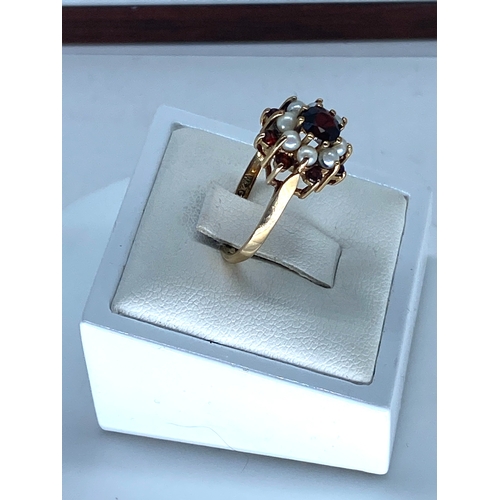 175 - A 9ct yellow gold garnet & pearl dress ring, size P, 2.8 grams on weight approx