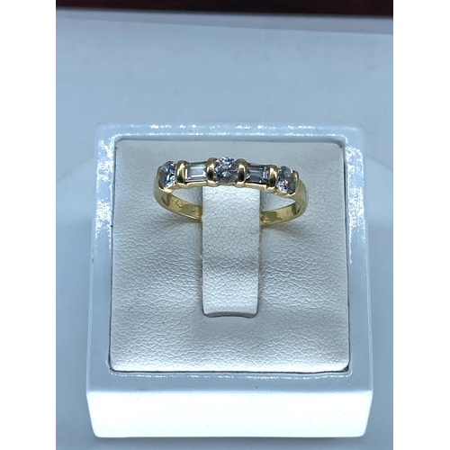 178 - An 18ct yellow gold emerald cut diamond ring, size Q, weight is 2.8 grams approx, set with 3 brillia... 