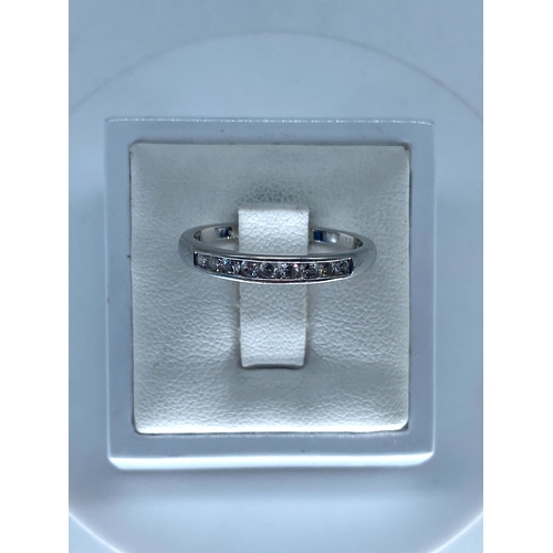 179 - A 9ct white gold diamond channel set eternity band, approx 0.25ct, size Q, 2.3 grams approx weight, ... 