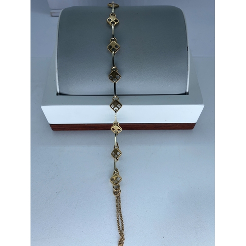 28 - A 9ct yellow & white gold link bracelet, comes with a safety chain, approx weight is 7 grams, 7 1/2 ... 