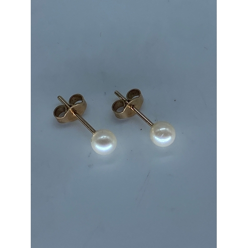 53 - A pair of 9ct yellow gold pearl stud earrings,  0.7 grams in weight approx, 4 - 5mm pearl,