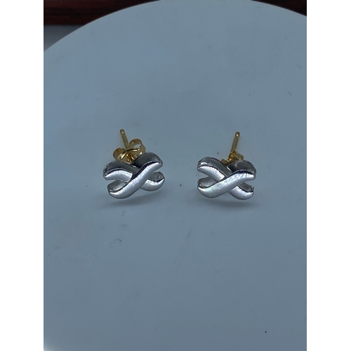 59 - A pair of 18ct white & yellow gold knot design earrings,  weight is 1.3 grams approx