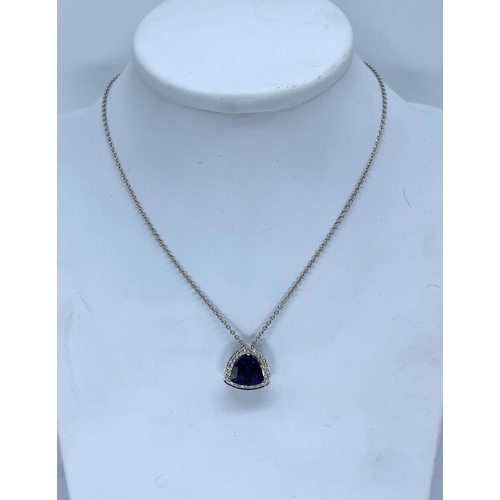 62 - An 18ct white gold large amethyst & diamond pendant & chain, amethyst is a triangle cut stone measur... 