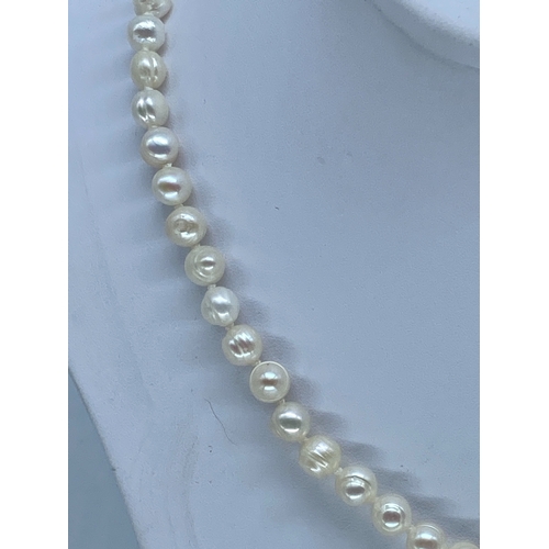 71 - A natural pearl necklace with a white metal clasp, 18 inches long, 5 - 6mm pearls,