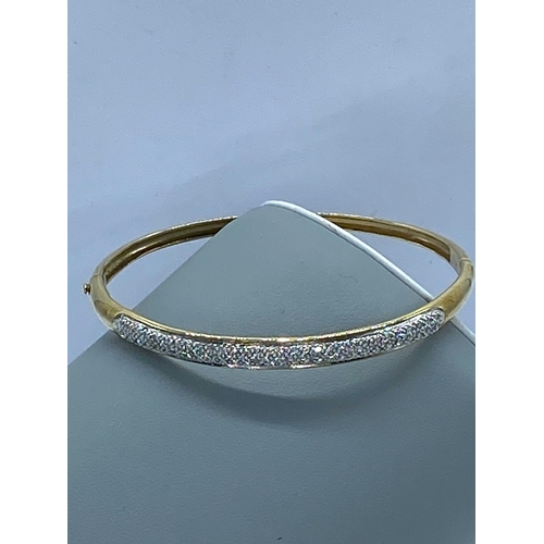 9 - A 9ct yellow gold diamond bangle, 10.6 grams in weight approx,  fully hallmarked, no damage, no ston... 