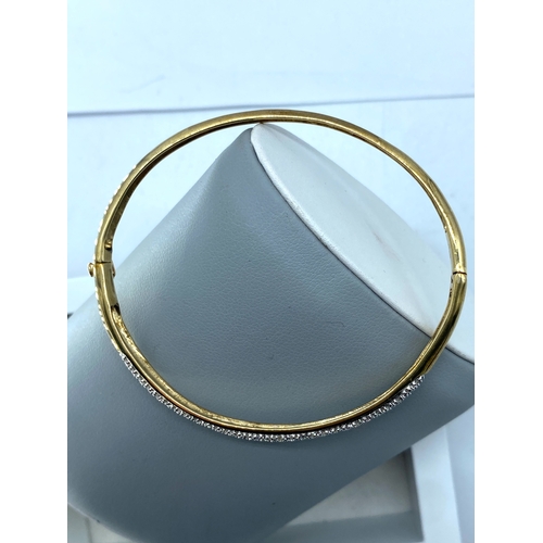 9 - A 9ct yellow gold diamond bangle, 10.6 grams in weight approx,  fully hallmarked, no damage, no ston... 