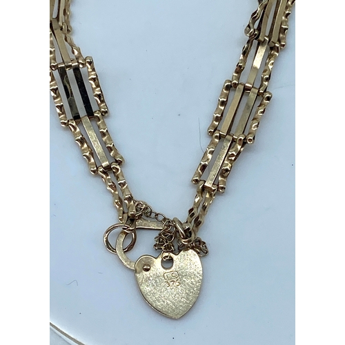 109 - A 9ct yellow gold gate bracelet, with heart locket & safety chain, weight is 3.4 grams approx,