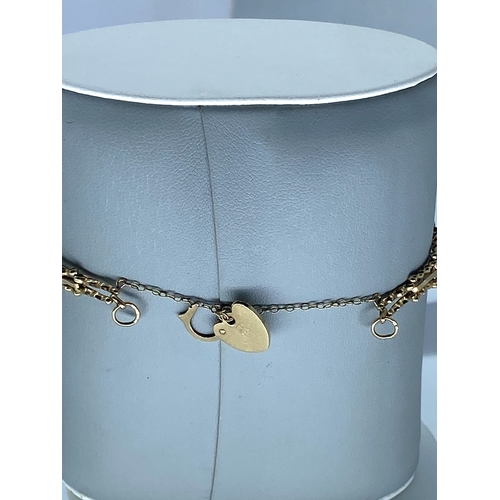 109 - A 9ct yellow gold gate bracelet, with heart locket & safety chain, weight is 3.4 grams approx,