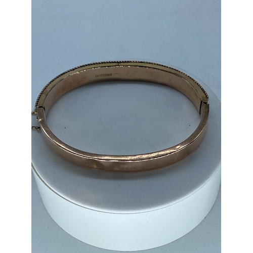 113 - A Victorian 9ct rose gold lace design bangle, has a safety chain, fully hallmarked, there are some a... 