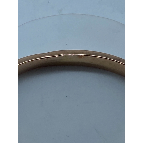 113 - A Victorian 9ct rose gold lace design bangle, has a safety chain, fully hallmarked, there are some a... 