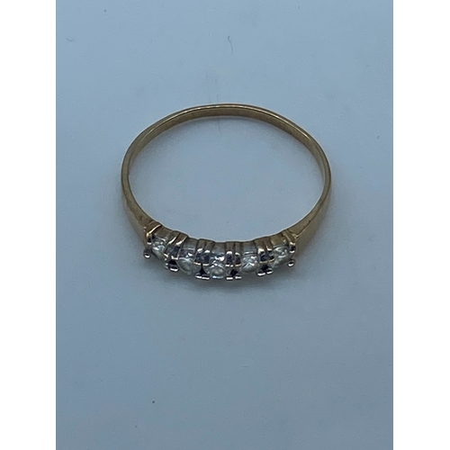 137 - A 9ct yellow gold 5 stone eternity band, stones are cz set, ring weighs 1.1 grams approx, size L 1/2