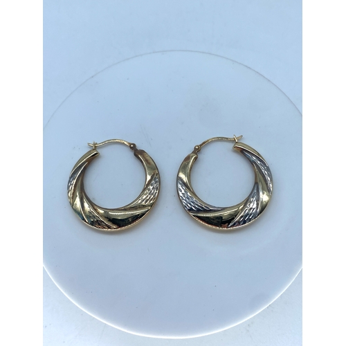 144 - A pair of 9ct white & yellow gold hooped earrings, weight is 1.4 grams approx, 24mm size,