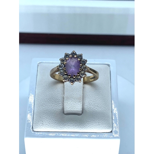 160 - A 9ct yellow gold amethyst dress ring, size N, weight is 3.4 grams approx, surrounding stones are cz